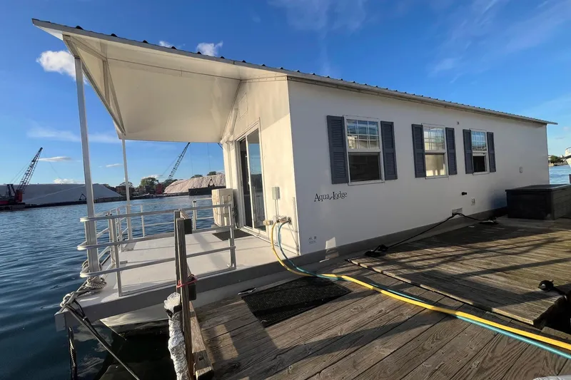 Slide: The Image of 2017 Catamaran Cruisers Aqualodge houseboat docked on a sunny day. - 27