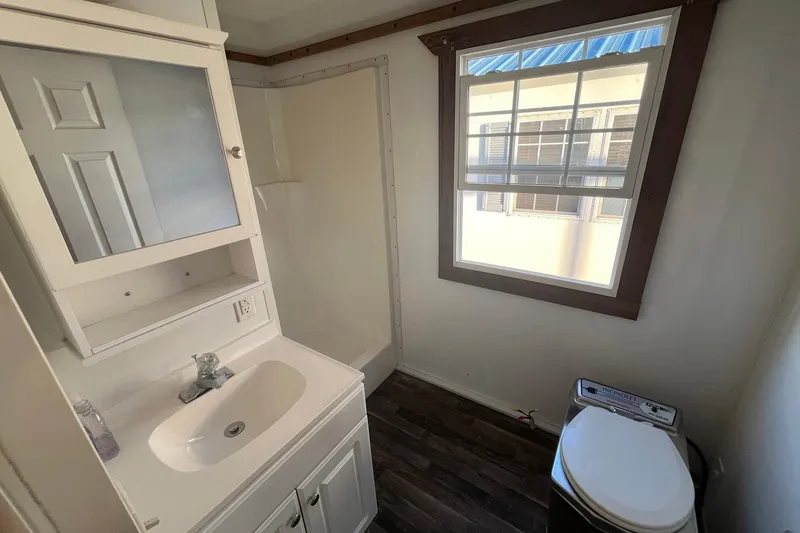 Slide: The Image of Bathroom interior of 2017 Catamaran Cruisers Aqualodge with sink, toilet, and window. - 28
