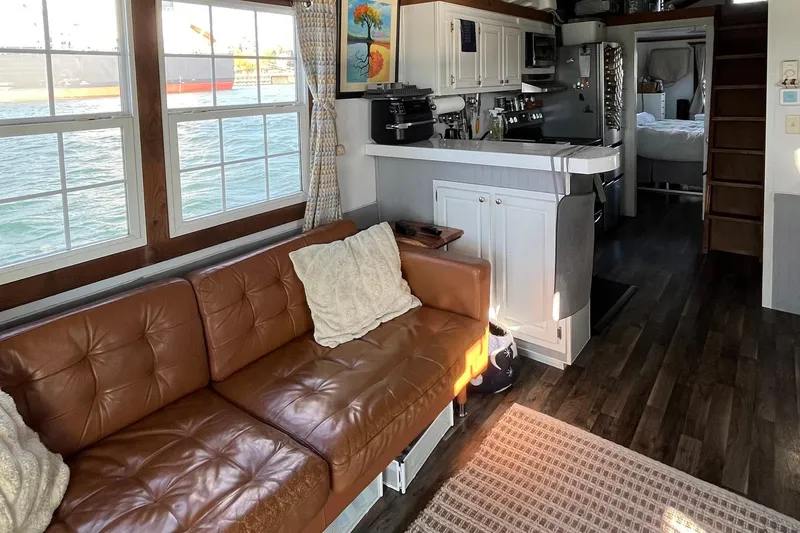 Slide: The Image of Interior of 2017 Catamaran Cruisers Aqualodge with cozy seating and kitchen area. - 5