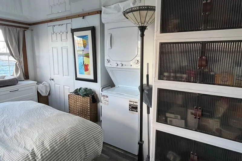 Slide: The Image of Interior of 2017 Catamaran Cruisers Aqualodge with bed, washer-dryer, and storage cabinets. - 9