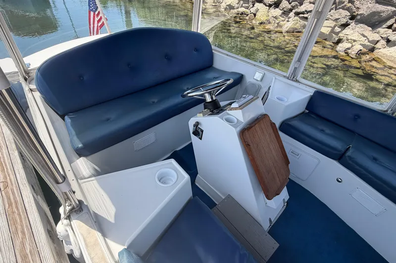 Slide: The Image of Interior of a 1996 Duffy Classic 21 boat with blue seating and steering console. - 13