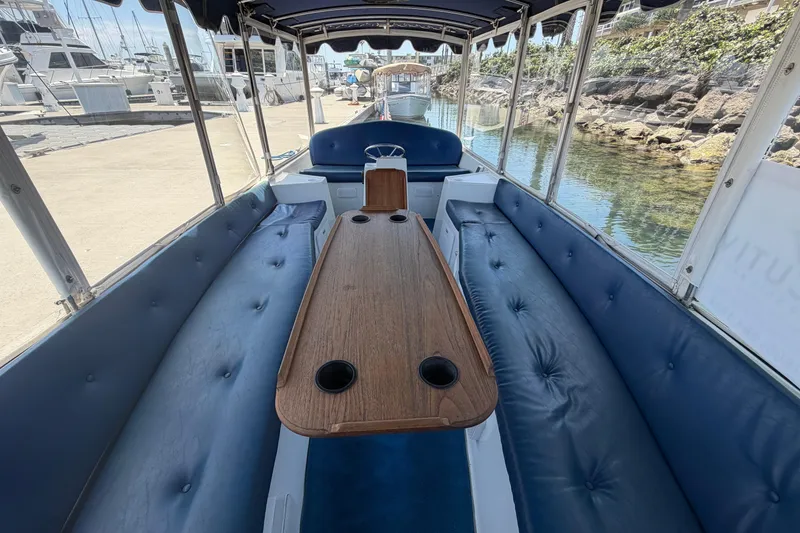 Slide: The Image of Interior of a 1996 Duffy Classic 21 boat with blue seating and wooden table. - 15