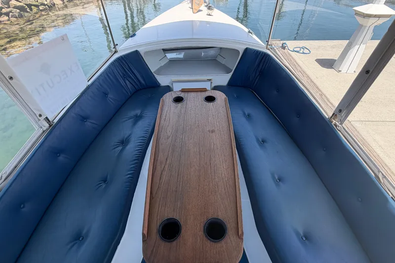 Slide: The Image of Interior of a 1996 Duffy Classic 21 boat with blue seating and wooden table. - 16