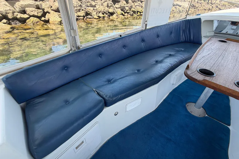 Slide: The Image of Interior of a 1996 Duffy Classic 21 boat with blue seating and wooden table. - 18