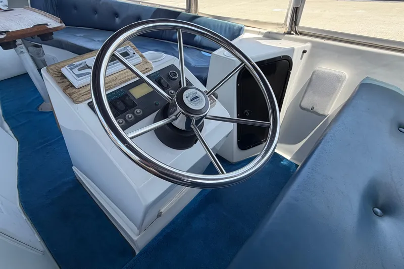 Slide: The Image of Interior view of a 1996 Duffy Classic 21 boat with steering wheel and control panel. - 19