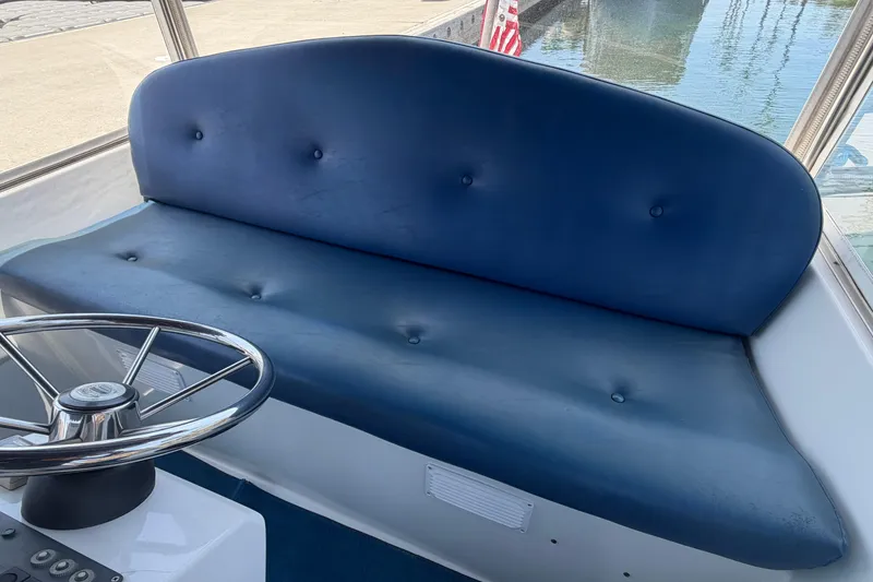 Slide: The Image of Blue cushioned seating and steering wheel on 1996 Duffy Classic 21 boat. - 21
