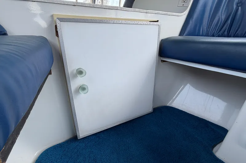 Slide: The Image of Interior of a 1996 Duffy Classic 21 boat with blue seating and carpet. - 23