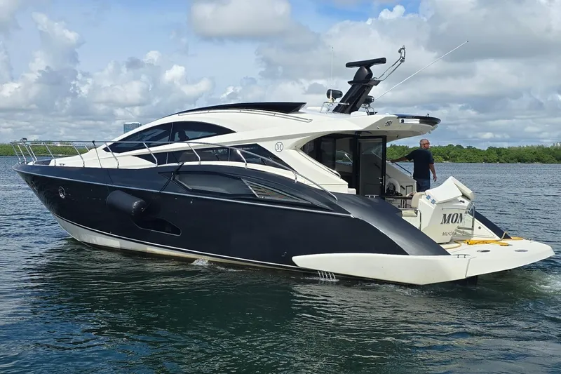 The Image of 2009 Marquis 500 Sport Coupe yacht cruising on a calm, scenic waterway. - 0