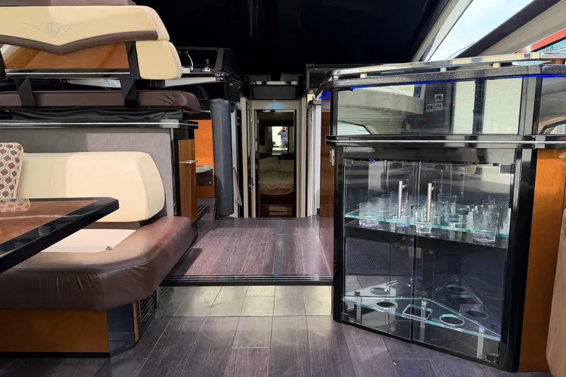 Slide: The Image of Luxurious interior of a 2009 Marquis 500 Sport Coupe yacht with elegant seating and glass cabinet. - 14