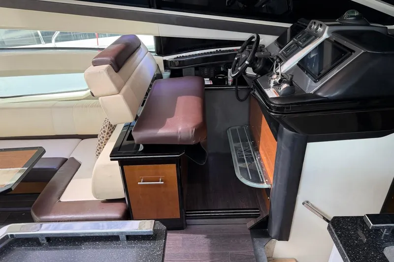 Slide: The Image of Interior of a 2009 Marquis 500 Sport Coupe yacht, featuring luxurious seating and modern controls. - 17