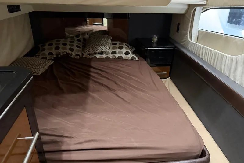 Slide: The Image of Cozy bedroom interior of 2009 Marquis 500 Sport Coupe yacht with brown bedding and pillows. - 24