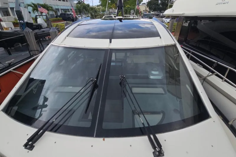 Slide: The Image of 2009 Marquis 500 Sport Coupe yacht with sleek windshield and wipers, docked at marina. - 4