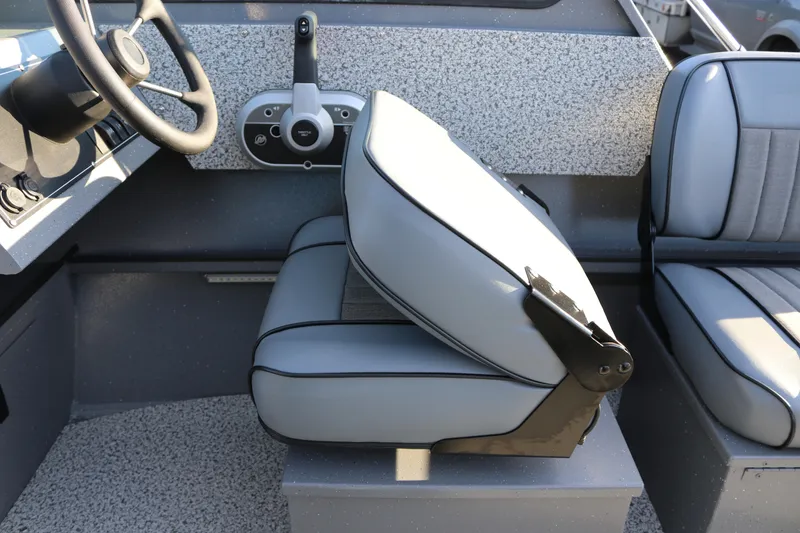 Slide: The Image of Interior of 2026 Alumaweld Stryker 220 boat with steering wheel and seating. - 24