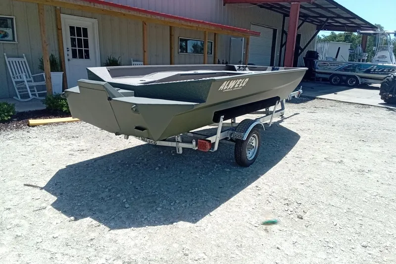 Slide: The Image of 2026 Alweld 1652 Invader boat on trailer, parked outside a building. - 10