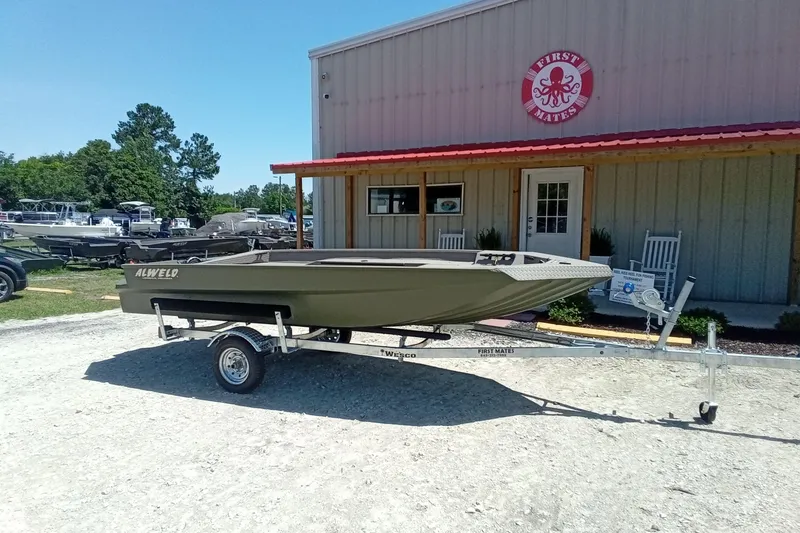 Slide: The Image of 2026 Alweld 1652 Invader boat on trailer outside a building. - 2