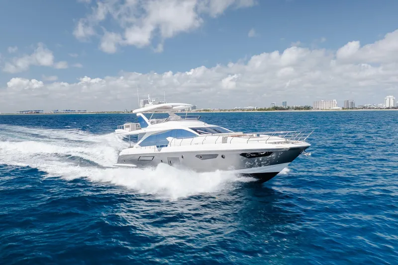 The Image of Luxurious 2017 Azimut Fly 72 yacht cruising on open blue waters under a clear sky. - 0