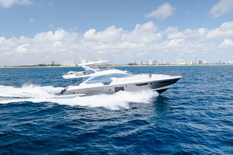 Slide: The Image of Luxurious 2017 Azimut Fly 72 yacht cruising on open blue sea under clear skies. - 3