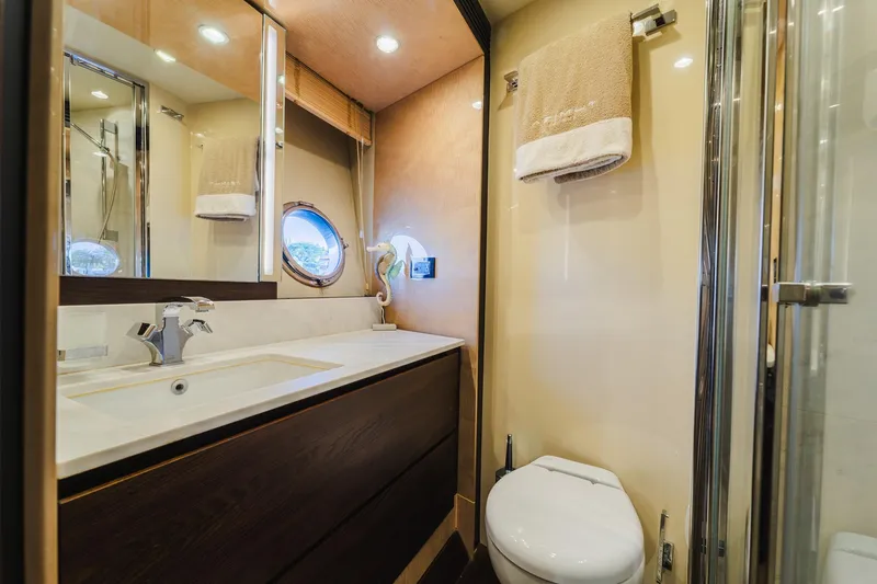 Slide: The Image of Luxurious bathroom interior of 2017 Azimut Fly 72 yacht with modern fixtures and porthole window. - 40