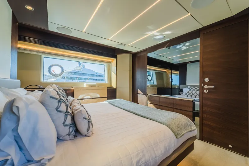Slide: The Image of Luxurious bedroom interior of 2017 Azimut Fly 72 yacht with elegant furnishings and large window. - 52