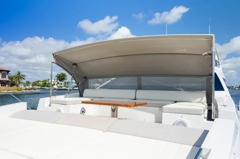 Slide: The Image of Luxurious 2017 Azimut Fly 72 yacht deck with seating and canopy under blue skies. - 55