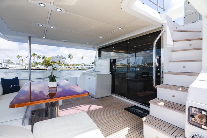 Slide: The Image of Luxurious 2017 Azimut Fly 72 yacht deck with elegant seating and scenic waterfront view. - 62