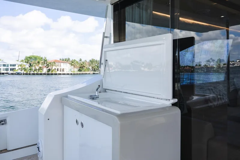 Slide: The Image of Luxury yacht Azimut Fly 72, 2017 model, featuring sleek outdoor sink area with scenic water view. - 63