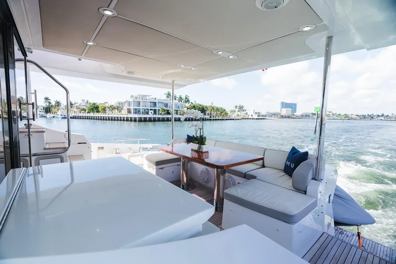 Slide: The Image of Luxurious 2017 Azimut Fly 72 yacht deck with elegant seating and scenic waterfront view. - 64