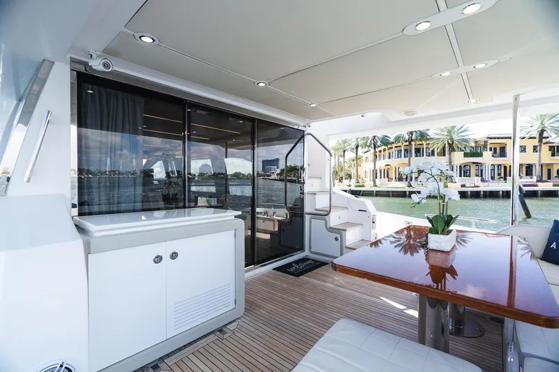 Slide: The Image of Luxurious 2017 Azimut Fly 72 yacht deck with elegant seating and waterfront view. - 65