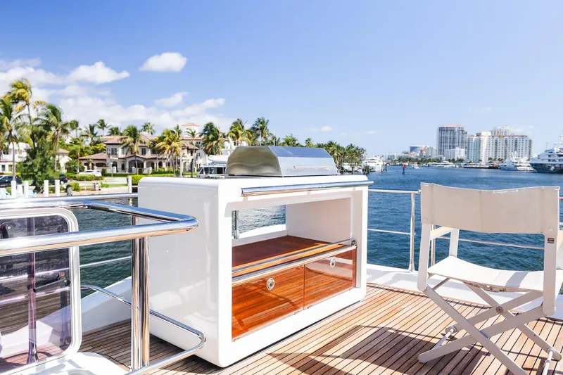Slide: The Image of Luxurious 2017 Azimut Fly 72 yacht deck with grill and scenic waterfront view. - 69