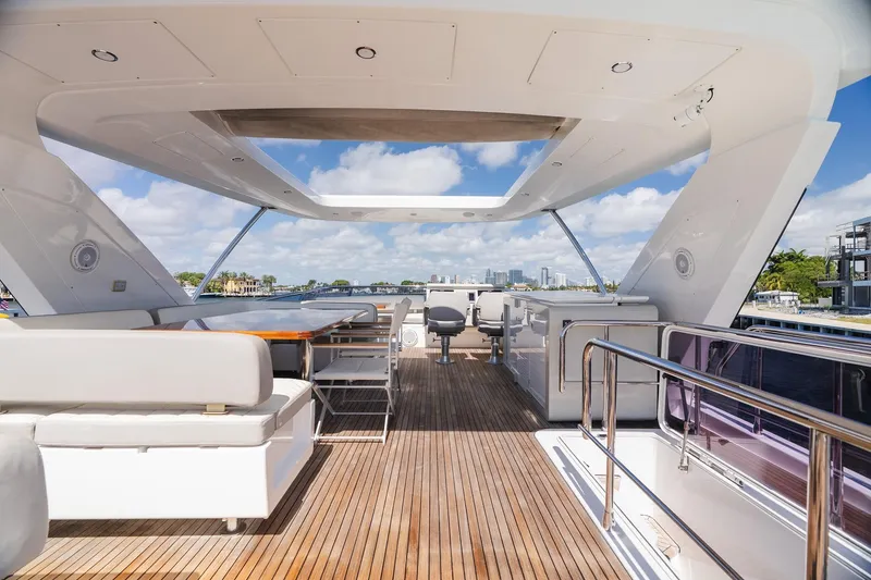 Slide: The Image of Luxurious 2017 Azimut Fly 72 yacht deck with modern seating and stunning waterfront views. - 74