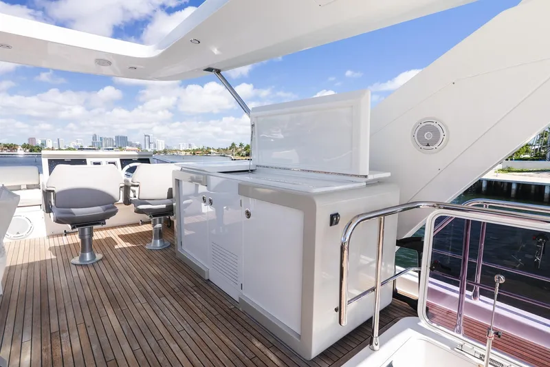 Slide: The Image of Luxurious 2017 Azimut Fly 72 yacht deck with seating and city skyline view. - 75