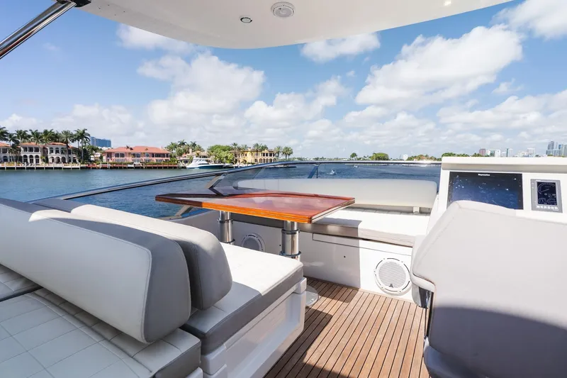 Slide: The Image of Luxurious 2017 Azimut Fly 72 yacht deck with seating, table, and waterfront view. - 76