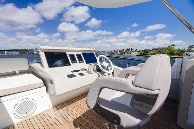 Slide: The Image of Luxurious helm of 2017 Azimut Fly 72 yacht with modern controls and scenic water view. - 78