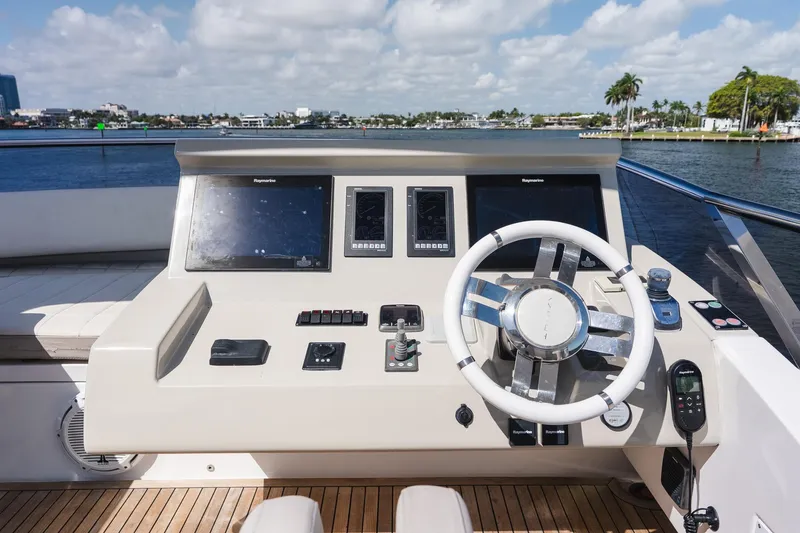 Slide: The Image of Cockpit of 2017 Azimut Fly 72 yacht with modern navigation controls and scenic water view. - 81