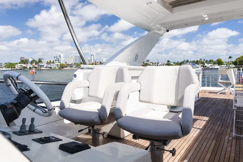 Slide: The Image of Luxury Azimut Fly 72 yacht helm with plush seating, overlooking scenic waterfront. - 85
