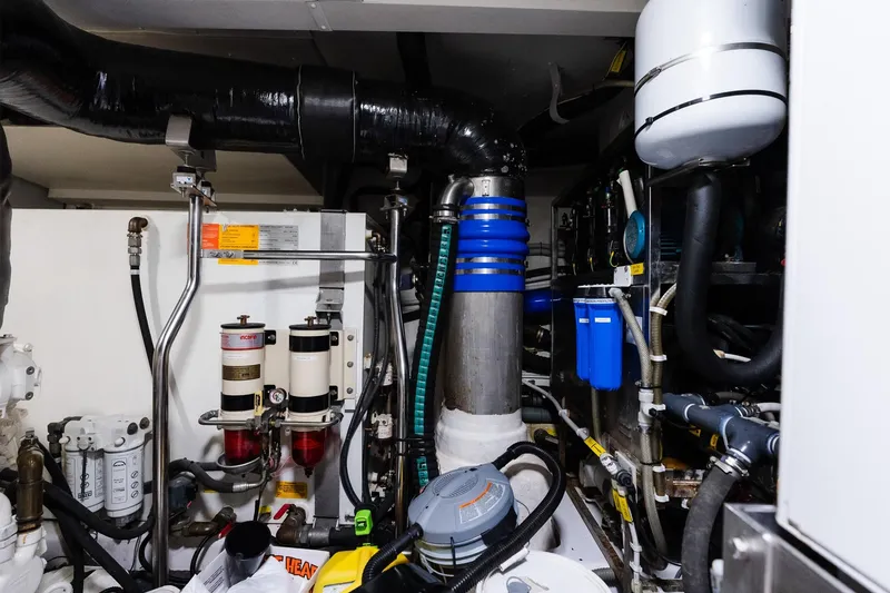 Slide: The Image of Engine room of a 2017 Azimut Fly 72 yacht, showcasing complex machinery and piping. - 92