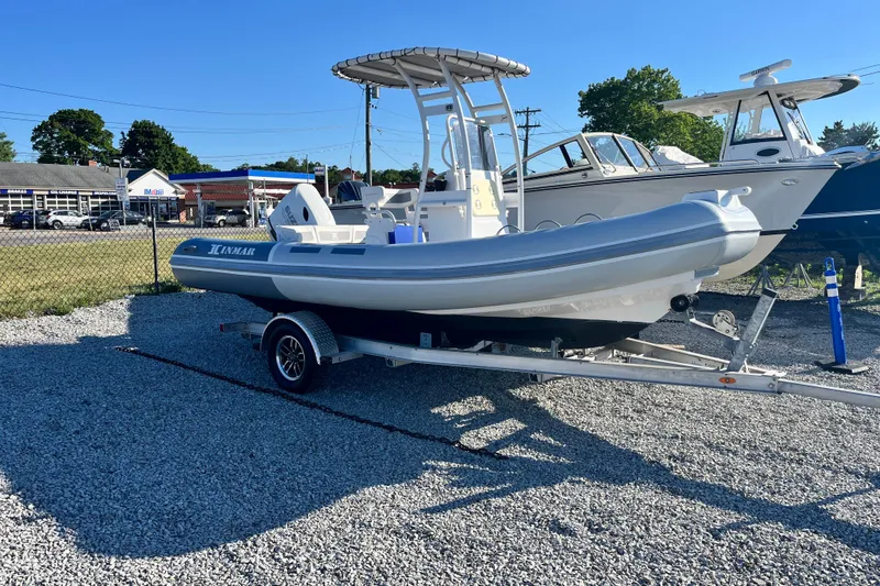 The Image of 2023 Inmar 550R-YS Yacht Series boat on trailer in outdoor setting. - 0