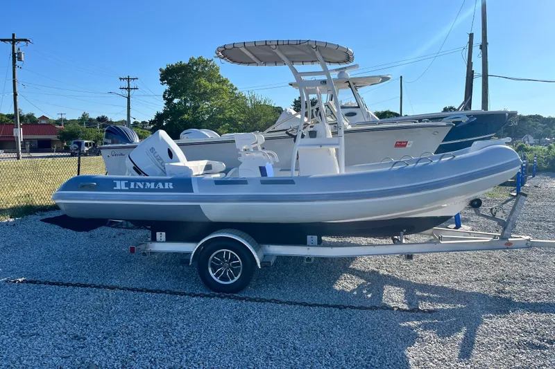 Slide: The Image of 2023 Inmar 550R-YS Yacht Series boat on trailer, parked outdoors on gravel. - 1