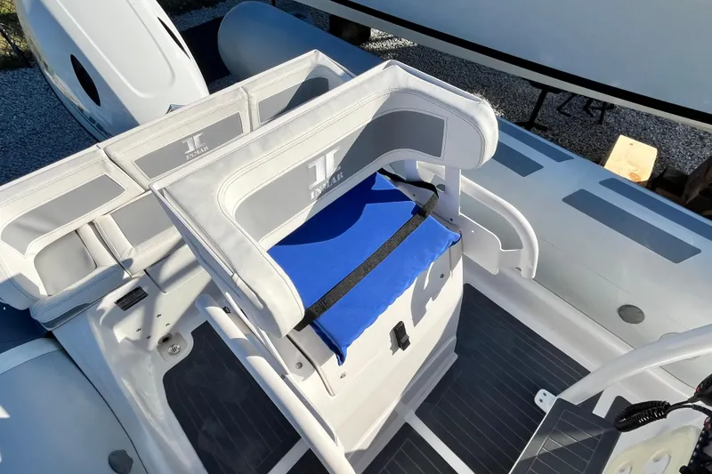 Slide: The Image of 2023 Inmar 550R-YS Yacht Series boat interior with cushioned seating and sleek design. - 14