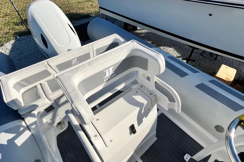 Slide: The Image of 2023 Inmar 550R-YS Yacht Series boat interior with seating and steering wheel. - 15