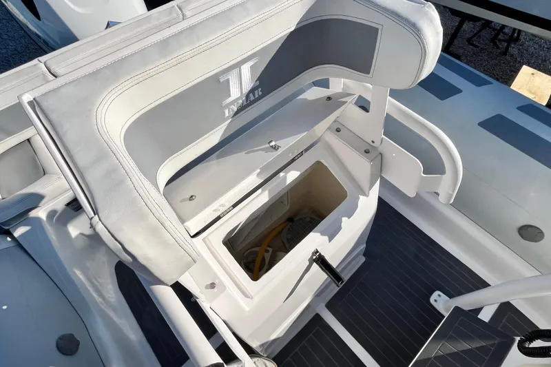 Slide: The Image of 2023 Inmar 550R-YS Yacht Series seat storage compartment open, showcasing interior space. - 16
