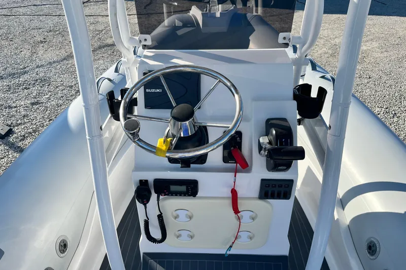 Slide: The Image of 2023 Inmar 550R-YS Yacht Series steering console with Suzuki controls and modern dashboard. - 17