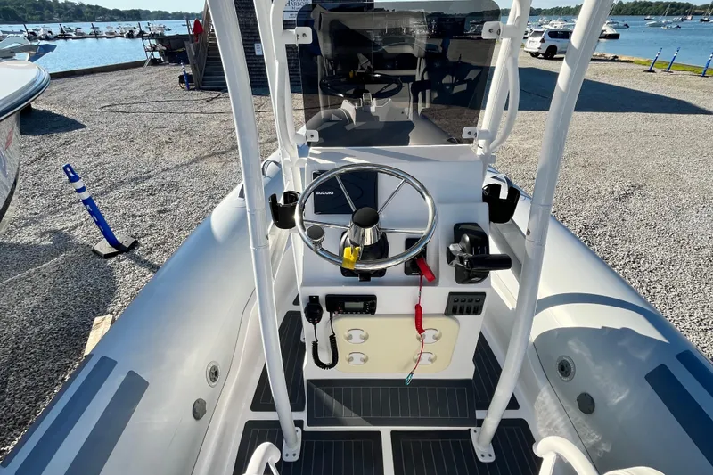 Slide: The Image of 2023 Inmar 550R-YS Yacht Series boat cockpit with steering wheel and controls, dockside view. - 19