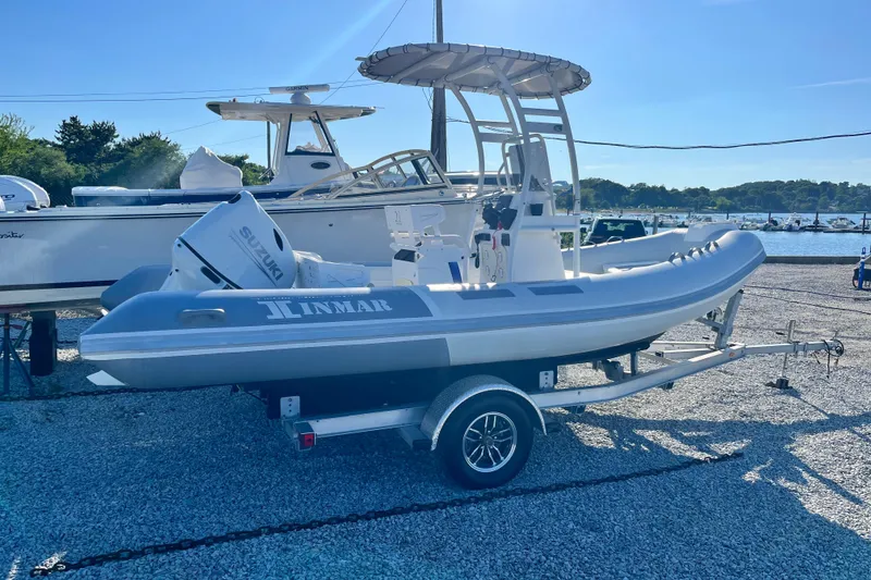 Slide: The Image of 2023 Inmar 550R-YS Yacht Series boat on trailer, featuring Suzuki outboard motor. - 2