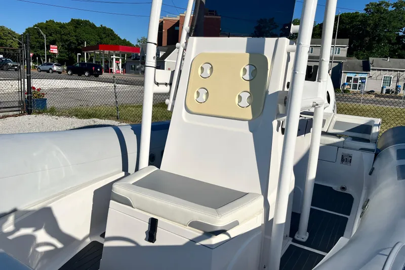 Slide: The Image of 2023 Inmar 550R-YS Yacht Series boat interior with seating and console, docked outdoors. - 22