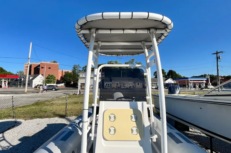 Slide: The Image of 2023 Inmar 550R-YS Yacht Series boat with canopy, parked outdoors on a sunny day. - 25
