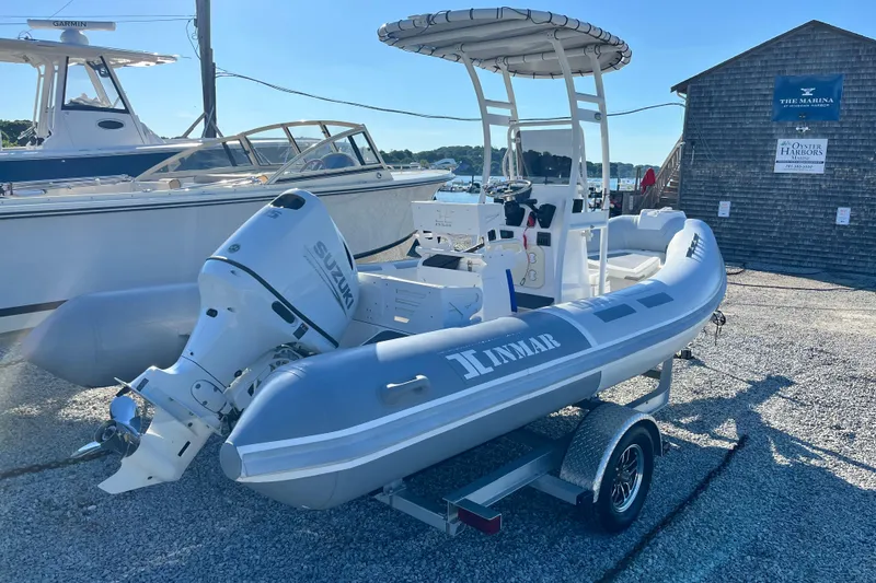 Slide: The Image of 2023 Inmar 550R-YS Yacht Series boat with Suzuki outboard motor on trailer at marina. - 3