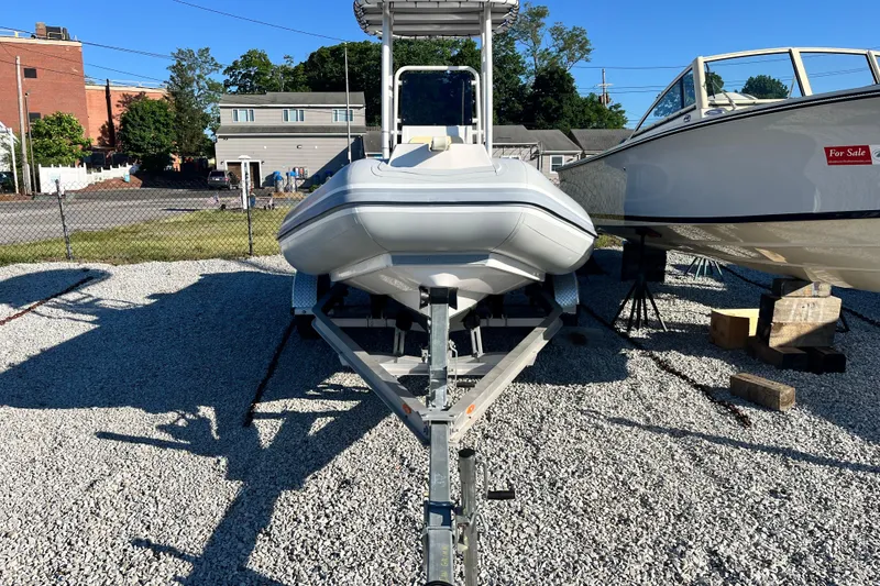 Slide: The Image of 2023 Inmar 550R-YS Yacht Series boat on trailer in outdoor lot. - 5