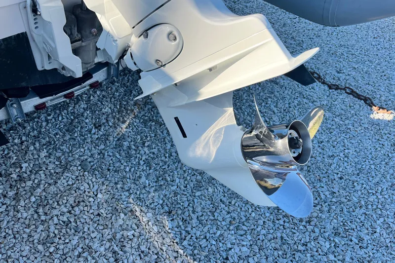 Slide: The Image of Outboard motor propeller of 2023 Inmar 550R-YS Yacht Series on gravel surface. - 7