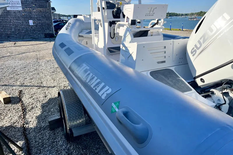 Slide: The Image of 2023 Inmar 550R-YS Yacht Series boat with Suzuki engine, docked near waterfront. - 8